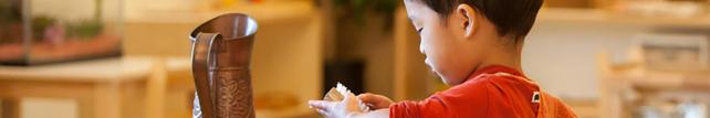 Child hand washing in a Montessori classroom