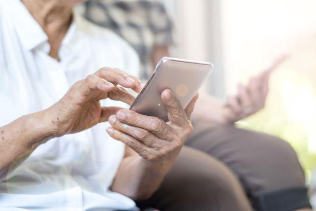 Elderly person using mobile phone