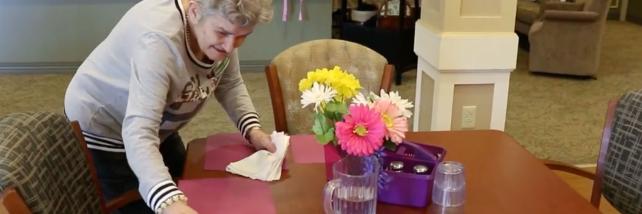 Resident setting the table for dinner